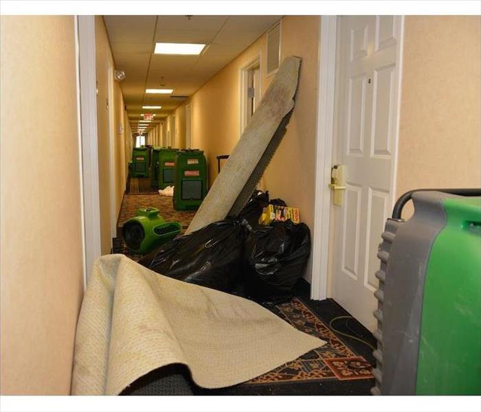 equipment and carpets stacked in the corridor