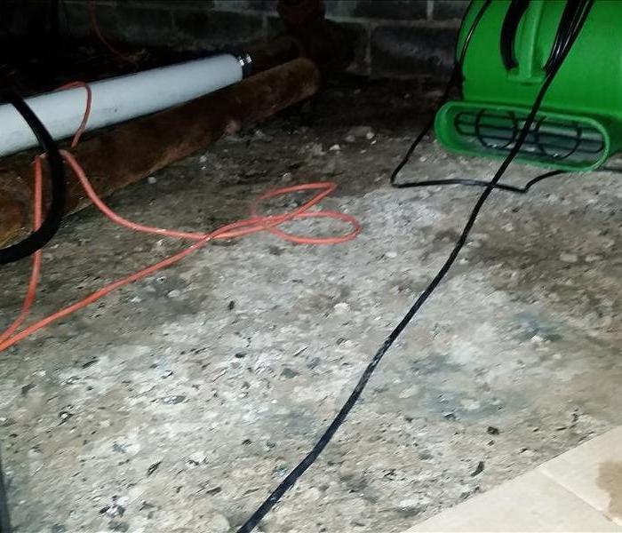 Concrete floor with servpro equipment on the floor. 