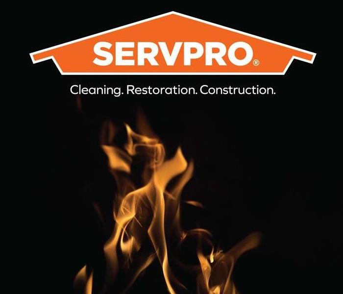 Black backdrop with a fire displaying servpro logo