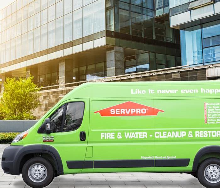 green SERVPRO van sitting in front of a building